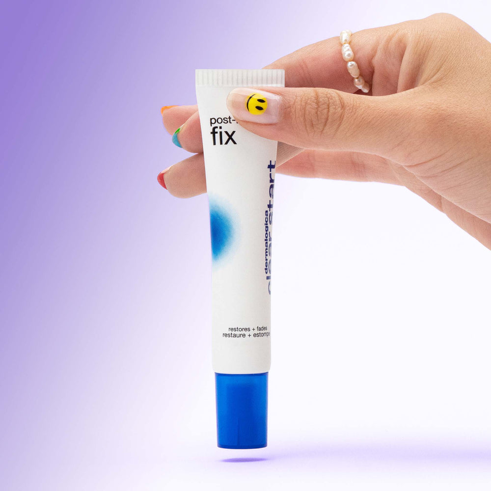 Hand holding a tube of 'post-breakout fix' against a gradient purple background