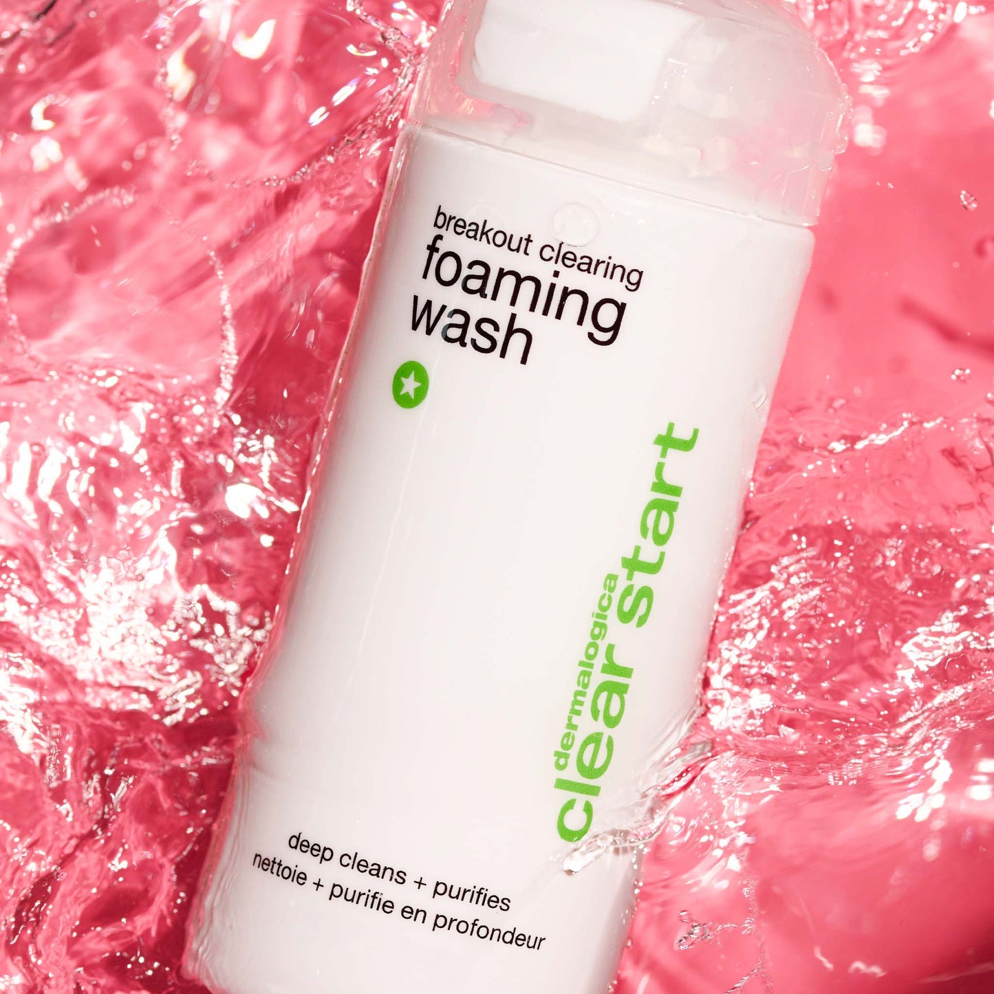 Dermalogica breakout clearing foaming wash bottle on a pink foamy background