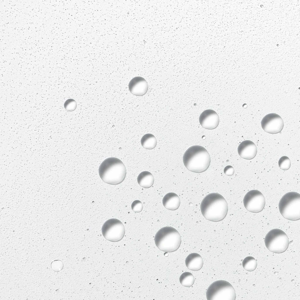 dermalogica hyaluronic ceramide mist droplets on a textured gray surface